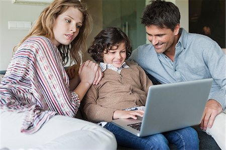 simsearch:6108-05867493,k - Boy using a laptop with his parents at home Foto de stock - Sin royalties Premium, Código: 6108-06166987