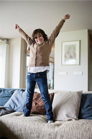 people cheering excite at home - Portrait of a boy having fun at home Stock Photo - Premium Royalty-Free, Code: 6108-06167056