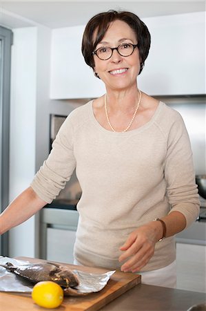 senior lifestyle cooking - Elderly woman preparing seafood in a kitchen Stock Photo - Premium Royalty-Free, Code: 6108-06167070