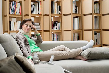 disabled women on crutches - Woman resting on a couch Stock Photo - Premium Royalty-Free, Code: 6108-06167078