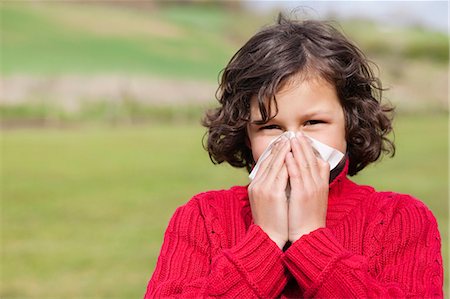 sneezing child - Portrait of a boy blowing his nose Stock Photo - Premium Royalty-Free, Code: 6108-06167001