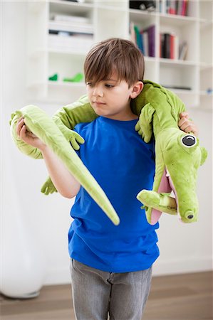 stuffed animal (toy) - Boy playing with animals toys Stock Photo - Premium Royalty-Free, Code: 6108-06167014