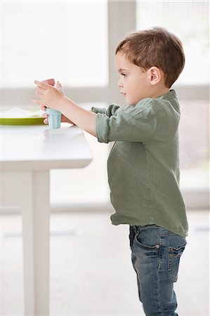 playful children - Boy playing with toys Stock Photo - Premium Royalty-Free, Code: 6108-06167025