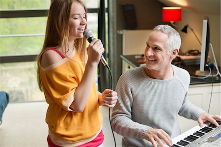 simsearch:6108-06167245,k - Man playing a piano with his daughter singing Stock Photo - Premium Royalty-Free, Code: 6108-06167185