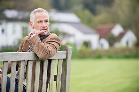 people on park benches - Man sitting on a bench and thinking in a park Stock Photo - Premium Royalty-Free, Code: 6108-06167133