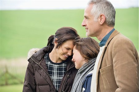 Happy family in a field Stock Photo - Premium Royalty-Free, Code: 6108-06167231