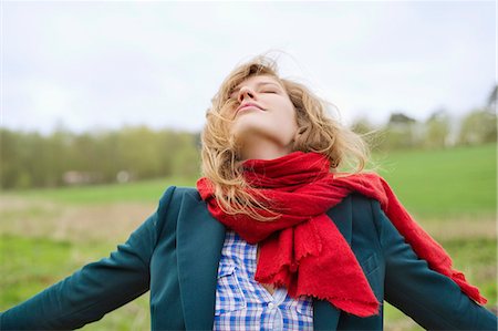 Beautiful woman daydreaming in a field Stock Photo - Premium Royalty-Free, Code: 6108-06167343