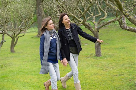 sweater mature women - Woman with her daughter walking in an orchard Stock Photo - Premium Royalty-Free, Code: 6108-06167350