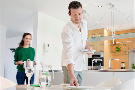 dining 30s two people - Couple preparing to serve dinner Stock Photo - Premium Royalty-Free, Code: 6108-06167399