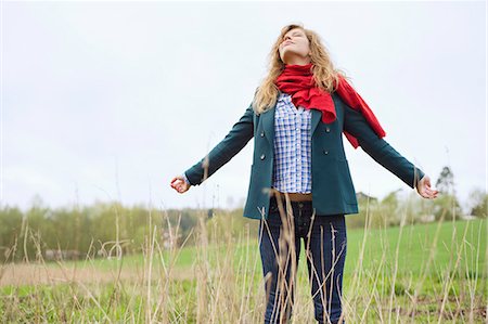 sweater winter - Beautiful woman daydreaming in a field Stock Photo - Premium Royalty-Free, Code: 6108-06167326