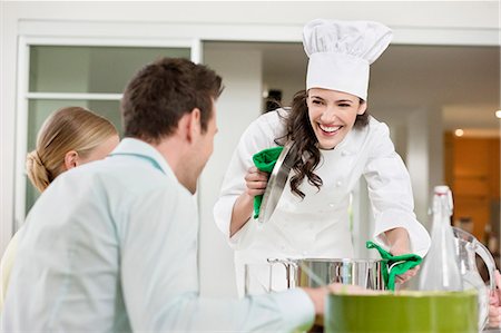 serving - Happy female chef serving food Stock Photo - Premium Royalty-Free, Code: 6108-06167457