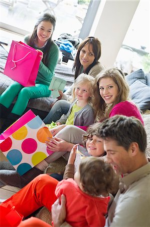 Happy family sitting together at home Stock Photo - Premium Royalty-Free, Code: 6108-06167491