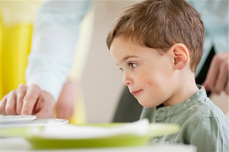 simsearch:6108-06167425,k - Boy sitting at a dining table Stock Photo - Premium Royalty-Free, Code: 6108-06167406