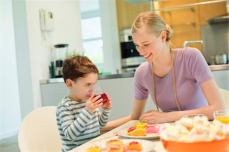 people eating on dining table - Woman and son at breakfast table Stock Photo - Premium Royalty-Free, Code: 6108-06167417