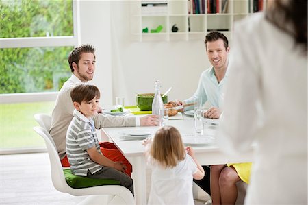 photos of a dad dining with his son - Happy family at dining table Stock Photo - Premium Royalty-Free, Code: 6108-06167420