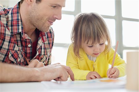 student studying home - Man teaching his daughter Stock Photo - Premium Royalty-Free, Code: 6108-06167559