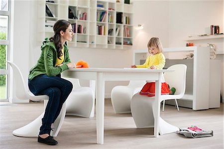 Woman teaching her daughter at home Stock Photo - Premium Royalty-Free, Code: 6108-06167561