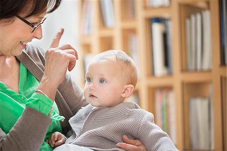 senior and baby - Woman playing with her granddaughter Stock Photo - Premium Royalty-Free, Code: 6108-06167646