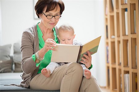 Woman with her granddaughter reading a picture book Stock Photo - Premium Royalty-Free, Code: 6108-06167653