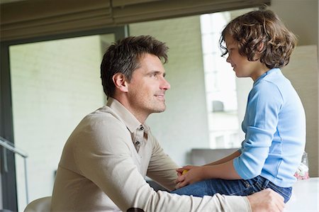 father son looking at each other - Man with his son looking at each other at home Stock Photo - Premium Royalty-Free, Code: 6108-06167604