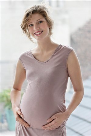 stomach (upper abdomen) - Pregnant woman smiling Stock Photo - Premium Royalty-Free, Code: 6108-06167716