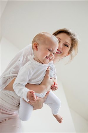 simsearch:6108-06166624,k - Woman playing with her daughter and smiling Stock Photo - Premium Royalty-Free, Code: 6108-06167726