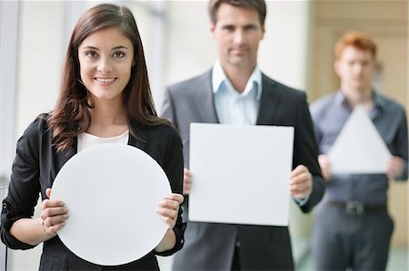 Business executives holding geometrical shaped placards in an office Foto de stock - Sin royalties Premium, Código: 6108-06167855