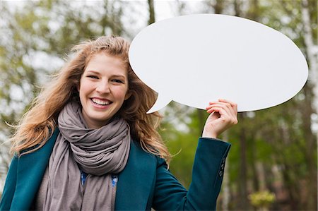 simsearch:6108-06167873,k - Woman holding a speech bubble Stock Photo - Premium Royalty-Free, Code: 6108-06167856