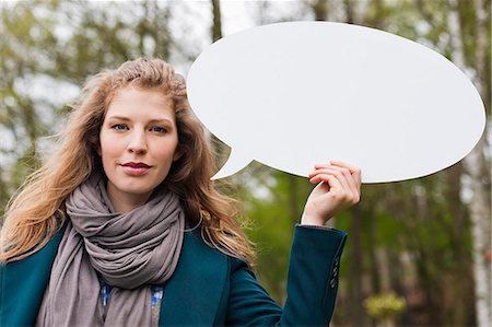 simsearch:6108-06167873,k - Woman holding a speech bubble Stock Photo - Premium Royalty-Free, Code: 6108-06167875