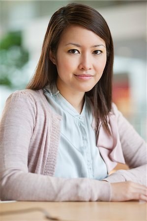 smiling businesswoman in office - Portrait of a businesswoman smiling Stock Photo - Premium Royalty-Free, Code: 6108-06167836