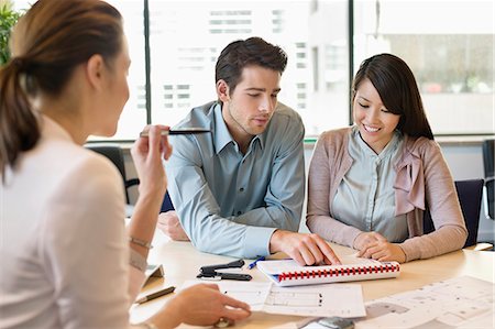 Real estate agent discussing property documents to his clients Fotografie stock - Premium Royalty-Free, Codice: 6108-06167946