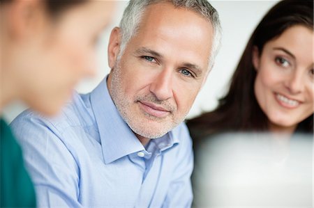 smiling corporate man woman - Business executives having a meeting in an office Stock Photo - Premium Royalty-Free, Code: 6108-06167967