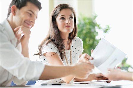 person working with papers - Business executives having a meeting in an office Stock Photo - Premium Royalty-Free, Code: 6108-06167912