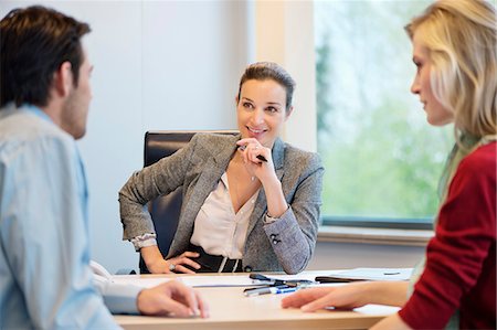 female real estate agent - Business executive discussing with her clients Stock Photo - Premium Royalty-Free, Code: 6108-06167929