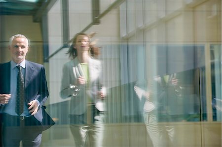running in corridors - Two business executives running in the corridor Stock Photo - Premium Royalty-Free, Code: 6108-06168040