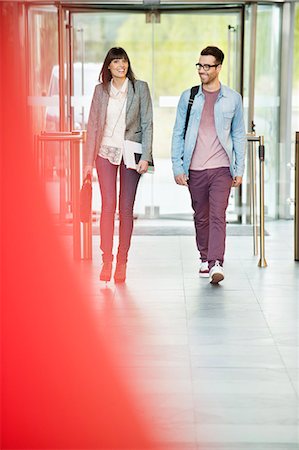 people walking modern - Business executives entering in an office lobby Stock Photo - Premium Royalty-Free, Code: 6108-06168064