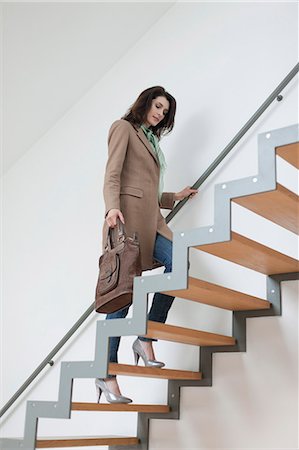 stairs inside house - Woman moving up stairs Stock Photo - Premium Royalty-Free, Code: 6108-06168080