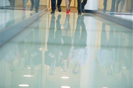 reflection (visual) - Reflection of business executives on the glassy floor Stock Photo - Premium Royalty-Free, Code: 6108-06168081