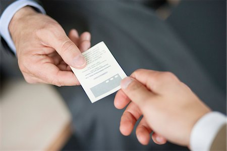 Close-up of Businessman giving card to another businessman Fotografie stock - Premium Royalty-Free, Codice: 6108-06168002