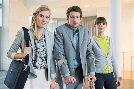 disability office - Disabled businessman standing with two women Foto de stock - Sin royalties Premium, Código: 6108-06168029