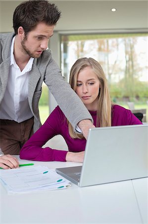 female business presentation pointing - Couple working in home office Stock Photo - Premium Royalty-Free, Code: 6108-06168142