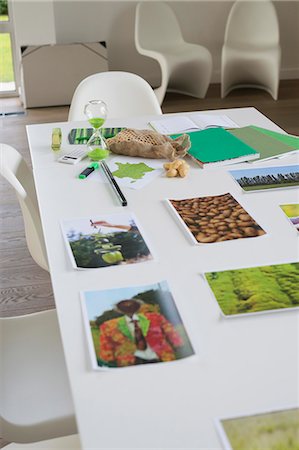 Ecology sustainable development related photographs on a table Stock Photo - Premium Royalty-Free, Code: 6108-06168114