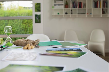 Ecology sustainable development related photographs on a table Stock Photo - Premium Royalty-Free, Code: 6108-06168122