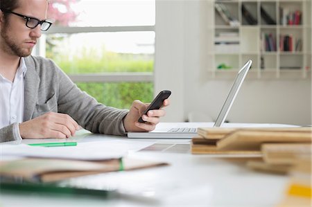 engineer on phone - Interior designer using a mobile phone in the office Stock Photo - Premium Royalty-Free, Code: 6108-06168135