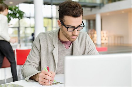 single person working on computer at desk - Male fashion designer working in an office Stock Photo - Premium Royalty-Free, Code: 6108-06168264