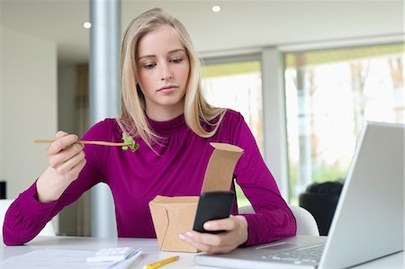 phone female office worker - Businesswoman eating salad while working in the home office Stock Photo - Premium Royalty-Free, Code: 6108-06168297