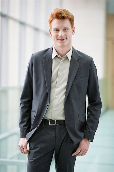 Portrait of a businessman smiling Stock Photo - Premium Royalty-Free, Image code: 6108-06168354