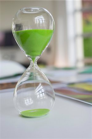 ecology - Close-up of an hourglass with green sand in it Stock Photo - Premium Royalty-Free, Code: 6108-06168372