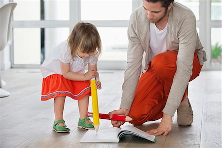 simsearch:6108-06167425,k - Man and daughter writing with big pencils Stock Photo - Premium Royalty-Free, Code: 6108-06168384