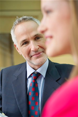 simsearch:6108-06168490,k - Business executives discussing in an office corridor Stock Photo - Premium Royalty-Free, Code: 6108-06168330